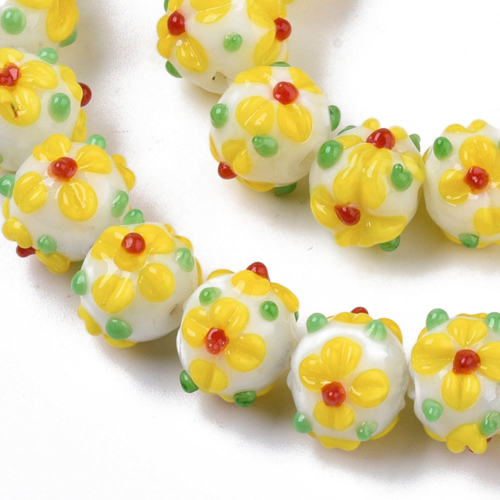 Yellow glass bead with flowers