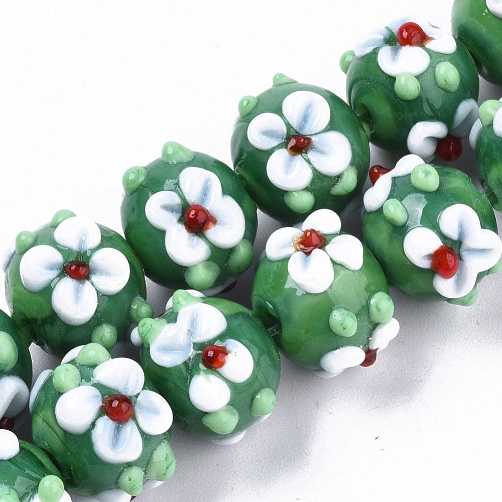 Green glass bead with flowers