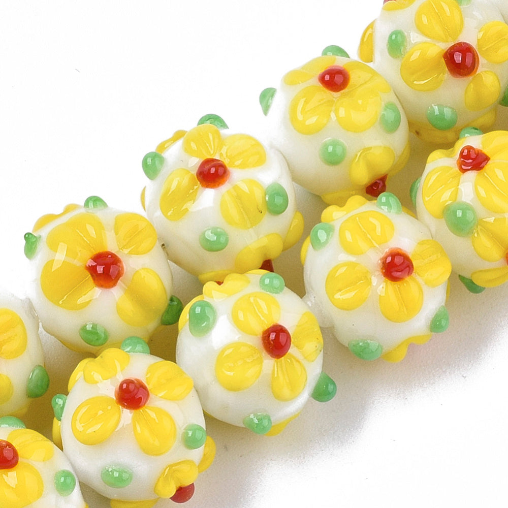 Yellow glass bead with flowers
