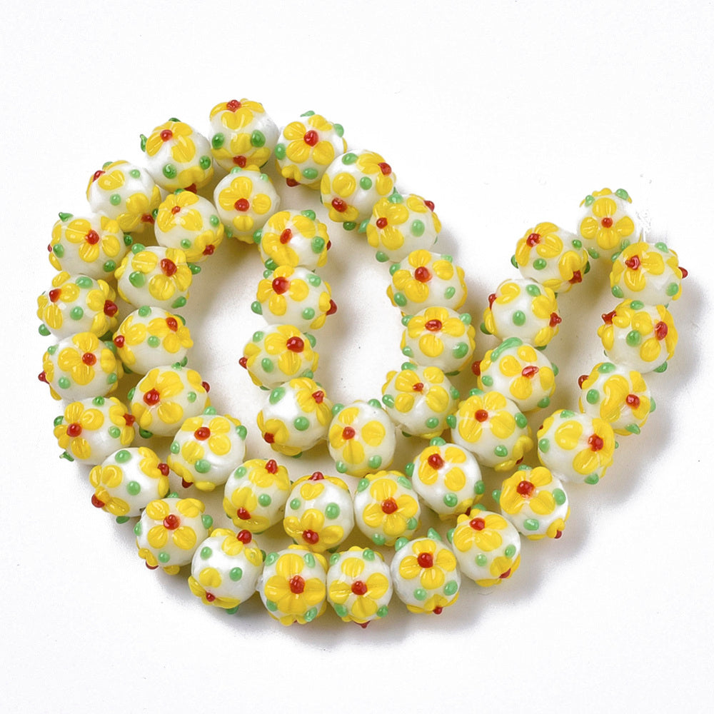 Yellow glass bead with flowers